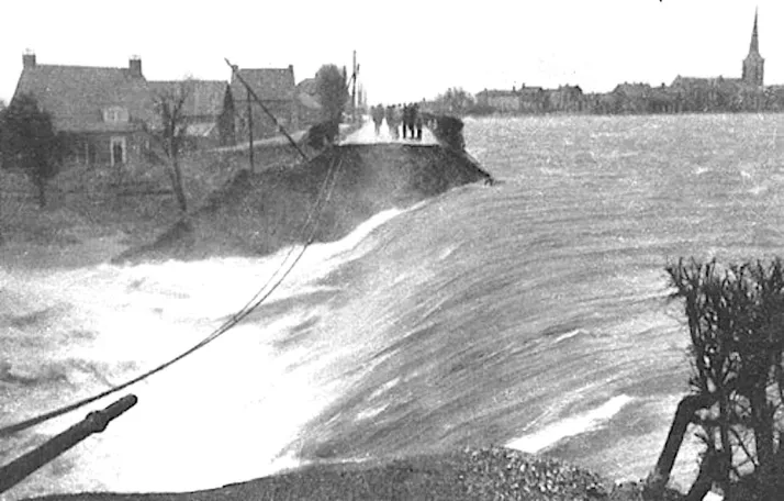 Black and white photograph of a dike breach during the 1953 flood